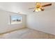 A basic bedroom featuring a ceiling fan and natural light at 881 W Kathryn Ave, Pahrump, NV 89060