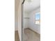 Empty walk-in closet with a window and a carpeted floor ready to be filled with your clothes and accessories at 881 W Kathryn Ave, Pahrump, NV 89060