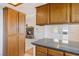 Open kitchen layout featuring granite counters, wood cabinets and backyard views at 881 W Kathryn Ave, Pahrump, NV 89060