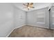 Carpeted bedroom with window featuring blinds, ceiling fan, and neutral paint at 9107 Wine Cellar Ave, Las Vegas, NV 89148