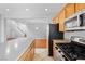 Bright kitchen featuring stainless steel appliances, tile floors and island with modern lighting fixture at 9107 Wine Cellar Ave, Las Vegas, NV 89148