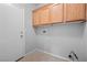 Convenient laundry room with storage cabinets, tiled floors and utility hookups at 9107 Wine Cellar Ave, Las Vegas, NV 89148