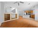 Open-concept living space with hardwood floors, built-in shelving, and a staircase at 9107 Wine Cellar Ave, Las Vegas, NV 89148
