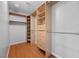 Well-organized walk-in closet features custom shelving, drawers, hanging racks, and wood flooring at 9107 Wine Cellar Ave, Las Vegas, NV 89148