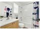 Bathroom featuring a shower-tub combo, a single sink vanity with white walls, and a window at 9322 Straw Hays St # 101, Las Vegas, NV 89178
