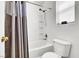 Bathroom with a shower-tub combo and a shower curtain, tiled walls and a window at 9322 Straw Hays St # 101, Las Vegas, NV 89178