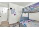 Bedroom featuring a bunk bed with colorful bedding, and access to the bathroom and closet at 9322 Straw Hays St # 101, Las Vegas, NV 89178