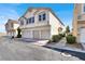 Modern townhouse featuring a three-car garage and well-maintained landscaping at 9322 Straw Hays St # 101, Las Vegas, NV 89178