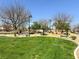 A grassy green space with seating and shaded picnic spots offers a relaxing outdoor area at 9322 Straw Hays St # 101, Las Vegas, NV 89178