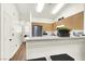 Bright kitchen featuring wood cabinets, stainless steel appliances, and a breakfast bar with seating at 9322 Straw Hays St # 101, Las Vegas, NV 89178