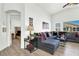 Spacious living room with a comfortable sectional sofa, natural light, and seamless access to the Primary bedroom at 9322 Straw Hays St # 101, Las Vegas, NV 89178