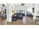 Bright, open living space with modern furnishings, hardwood floors, and seamless access to both the kitchen and a bedroom at 9322 Straw Hays St # 101, Las Vegas, NV 89178