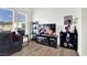 Cozy living room with a large TV, stylish shelving, and a comfortable gray sofa, perfect for relaxing at 9322 Straw Hays St # 101, Las Vegas, NV 89178