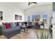 Inviting living room featuring a large sectional sofa, ample natural light, and stylish decor at 9322 Straw Hays St # 101, Las Vegas, NV 89178