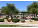 Community playground with exercise equipment and shaded picnic tables, perfect for Gathering fun at 9322 Straw Hays St # 101, Las Vegas, NV 89178