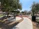 A community playground with picnic tables and exercise equipment beneath shade trees at 9322 Straw Hays St # 101, Las Vegas, NV 89178