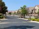 Gated entrance to a neighborhood with well-maintained landscaping and uniform architecture at 9322 Straw Hays St # 101, Las Vegas, NV 89178