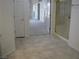 Tiled hallway leading to bedrooms with carpet flooring and a bathroom with glass shower doors at 10112 Plomosa Pl, Las Vegas, NV 89134