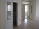 Bright hallway with tile flooring leading to a bathroom with a glass display cabinet at 10112 Plomosa Pl, Las Vegas, NV 89134