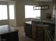 Bright kitchen featuring a stainless steel dishwasher and modern light fixture at 10112 Plomosa Pl, Las Vegas, NV 89134