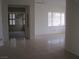 Bright living area with tile floors and a view to a second room with large windows at 10112 Plomosa Pl, Las Vegas, NV 89134