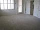 Spacious living room with large windows and natural light, neutral walls and carpet at 10112 Plomosa Pl, Las Vegas, NV 89134