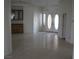 Bright living room with tile flooring, built-in bar, and double front doors at 10112 Plomosa Pl, Las Vegas, NV 89134