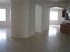 Open-concept living space with tile flooring, arched doorways, and a built-in bar area at 10112 Plomosa Pl, Las Vegas, NV 89134