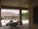 Covered patio featuring an outdoor dining area overlooking the refreshing pool and landscaped backyard at 10112 Plomosa Pl, Las Vegas, NV 89134