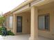 View of the covered patio showing access door, windows, and outdoor hose reel for yard maintenance at 10112 Plomosa Pl, Las Vegas, NV 89134