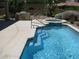 Backyard pool with steps leading into the water, attached spa and outdoor grill at 10112 Plomosa Pl, Las Vegas, NV 89134