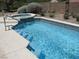 Backyard pool and spa with steps into the pool, perfect for cooling off on hot summer days at 10112 Plomosa Pl, Las Vegas, NV 89134