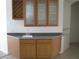 Stylish wet bar with a sink, wine rack, and glass-front cabinets for entertaining at 10112 Plomosa Pl, Las Vegas, NV 89134