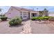 Inviting backyard showcasing a desert landscape, stone walkway, and covered patio for outdoor living at 10720 Bennington Ct, Las Vegas, NV 89134