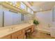 Bright bathroom with a double sink vanity, large mirror, and a soaking tub at 10720 Bennington Ct, Las Vegas, NV 89134