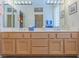 Bathroom with double sink vanity, decorative mirrors, and a well-lit, spacious countertop at 10720 Bennington Ct, Las Vegas, NV 89134