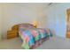 Cozy bedroom with bed featuring colorful patterned bedding, side table, and sliding closet doors at 10720 Bennington Ct, Las Vegas, NV 89134