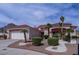 Attractive home exterior with desert landscaping, a two-car garage, and a charming, tiled roof at 10720 Bennington Ct, Las Vegas, NV 89134
