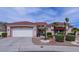 Charming single-story home with a tile roof, desert landscaping, and an attached two-car garage at 10720 Bennington Ct, Las Vegas, NV 89134