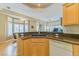 Well-equipped kitchen features an island, granite countertops, and wood flooring at 10720 Bennington Ct, Las Vegas, NV 89134