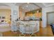 Charming kitchen with breakfast bar, light wood cabinets, and modern appliances at 10720 Bennington Ct, Las Vegas, NV 89134
