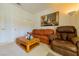 Comfortable living room featuring a cozy leather sofa, recliner, and a stylish wooden coffee table at 10720 Bennington Ct, Las Vegas, NV 89134