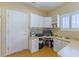 Functional office space with built-in desk, cabinets, and a bright window for natural light at 10720 Bennington Ct, Las Vegas, NV 89134