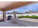 Comfortable covered patio with a grill, seating, and views of the mountains in the background at 10720 Bennington Ct, Las Vegas, NV 89134