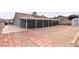A spacious backyard with a covered patio, gravel, and a brick pathway leading to a shed at 117 Saint Albans Ct, Henderson, NV 89015