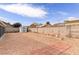 Gravel backyard featuring a shed and a block wall, providing privacy and storage at 117 Saint Albans Ct, Henderson, NV 89015