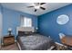 Cozy bedroom with blue walls and a ceiling fan at 117 Saint Albans Ct, Henderson, NV 89015