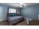 Comfortable bedroom with a ceiling fan, neutral colors, and vinyl floors at 117 Saint Albans Ct, Henderson, NV 89015