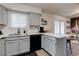 Modern kitchen with gray cabinets, stainless steel appliances, and a breakfast bar at 117 Saint Albans Ct, Henderson, NV 89015