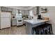 Charming kitchen featuring gray cabinets, a breakfast bar, and stainless hood at 117 Saint Albans Ct, Henderson, NV 89015